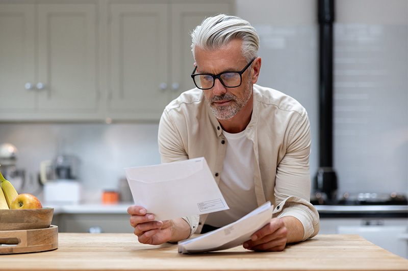 Middle-aged man looking through direct mail