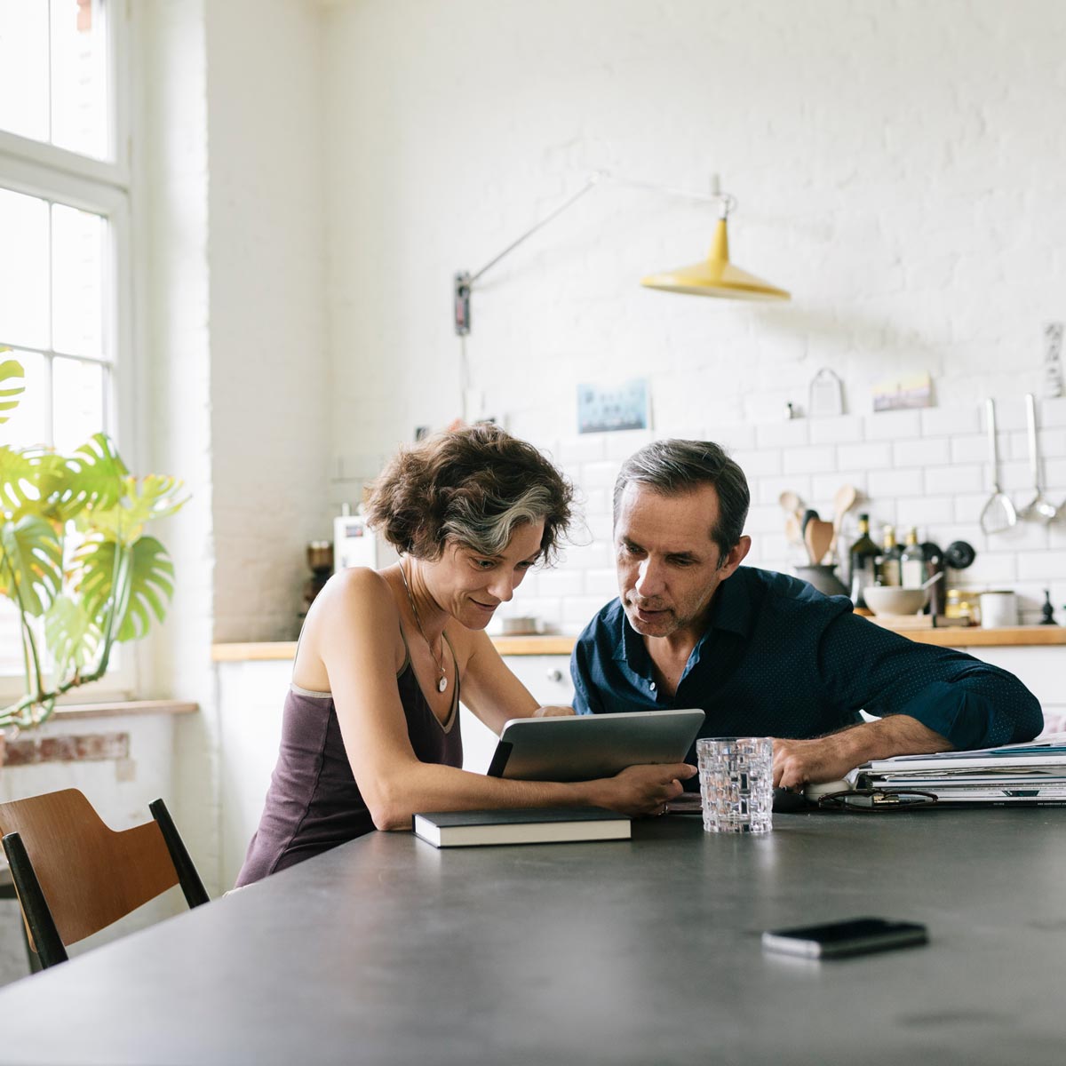 Middle-aged couple looking at information on their tablet