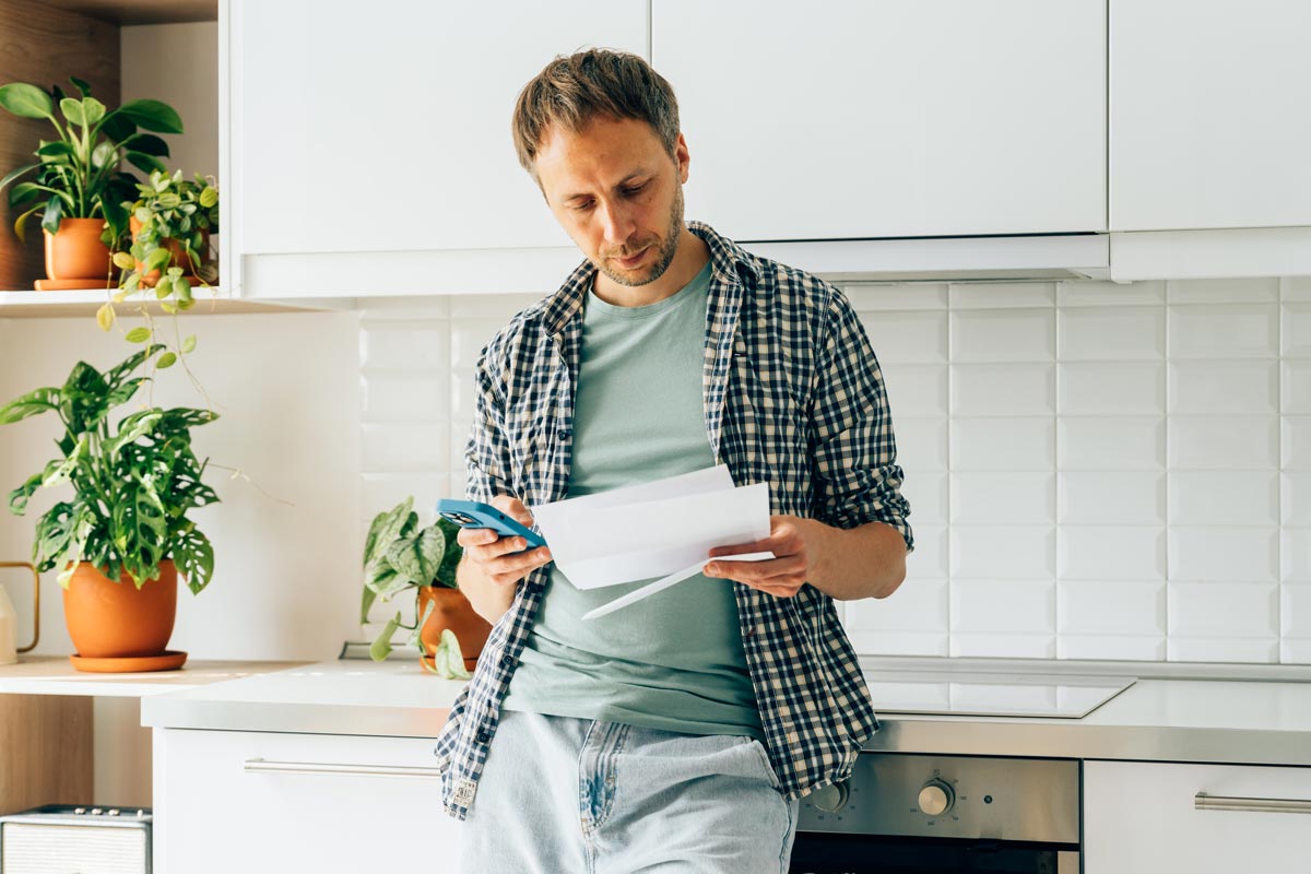 Person reading through their mail while in their household