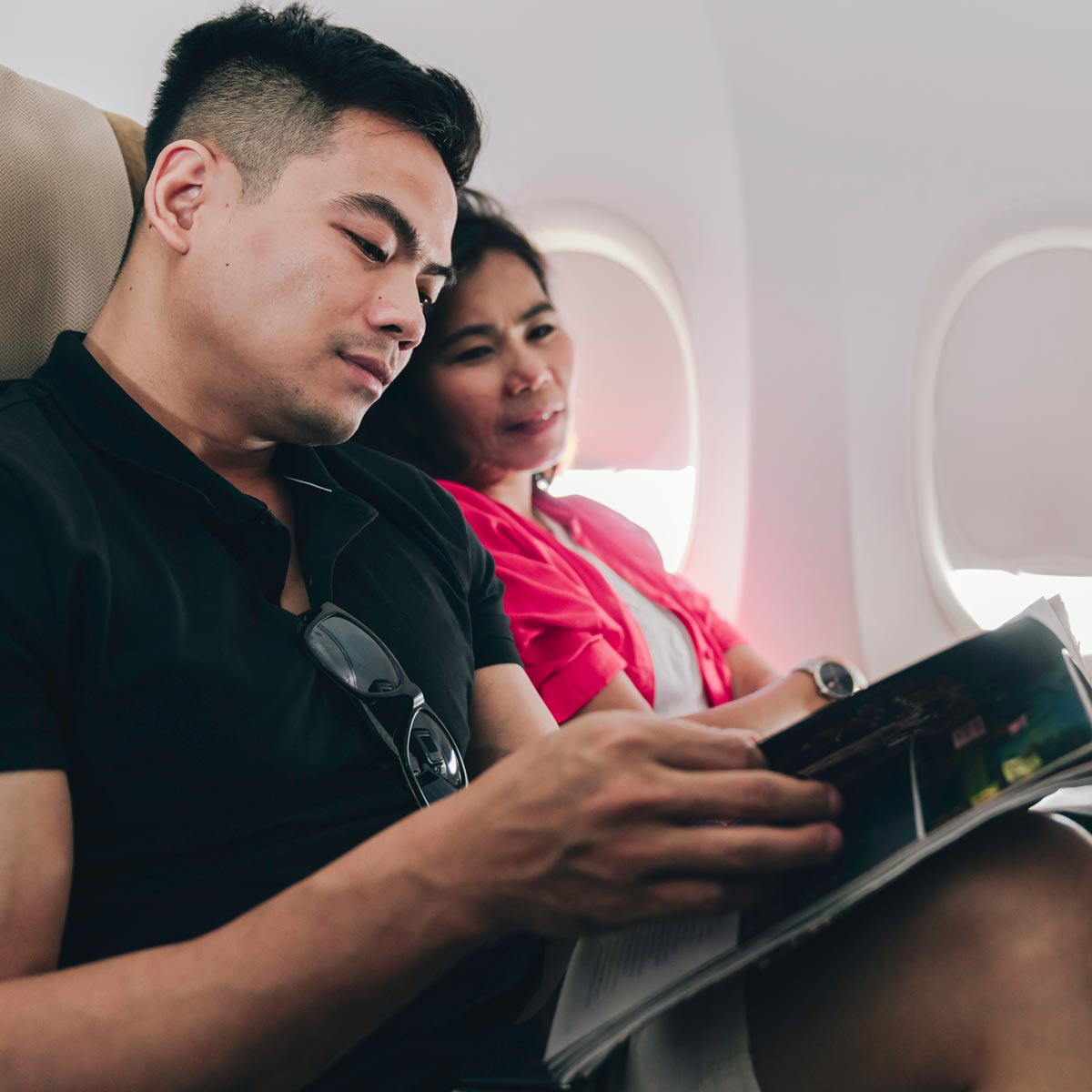 Young couple reading a magazine